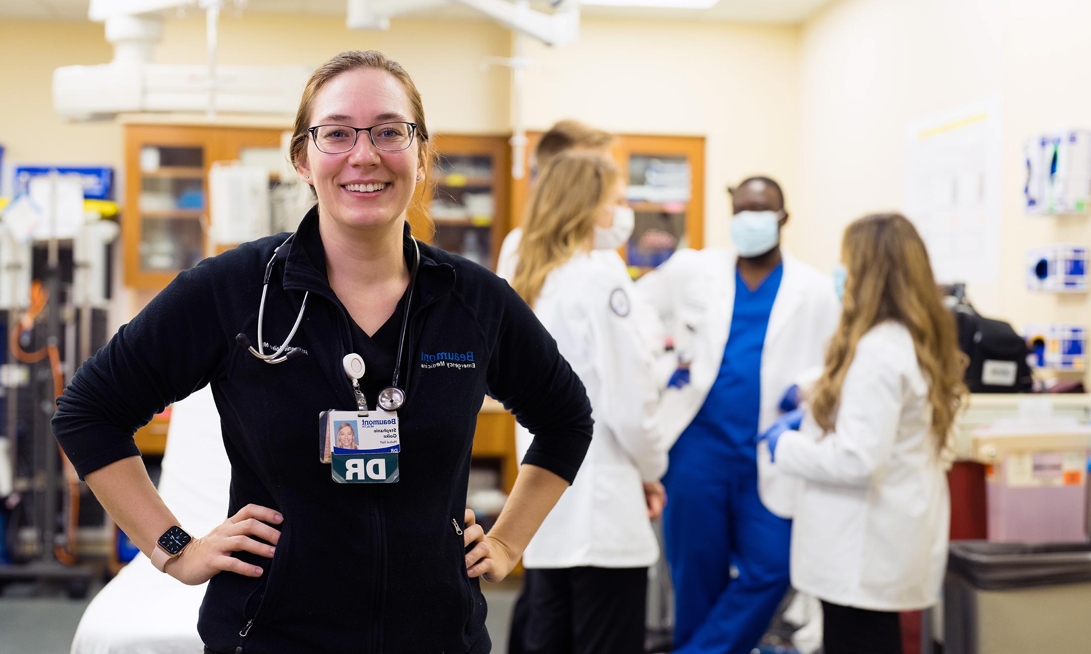 An image of Dr. Goike with OUWB students in the background