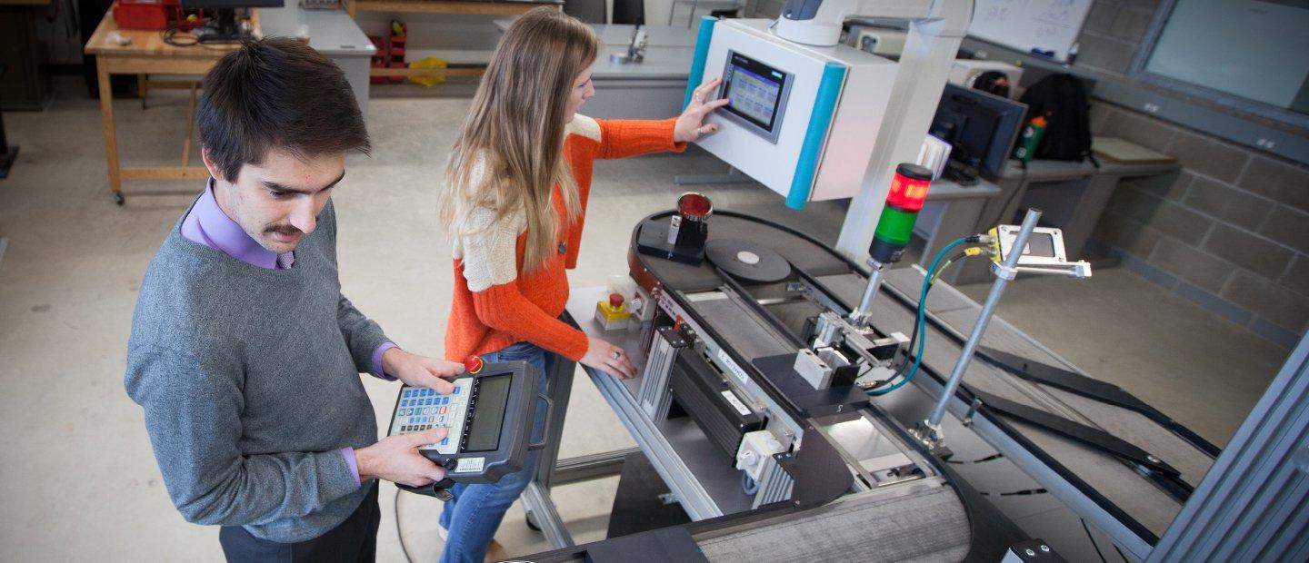 2 students working on a machine